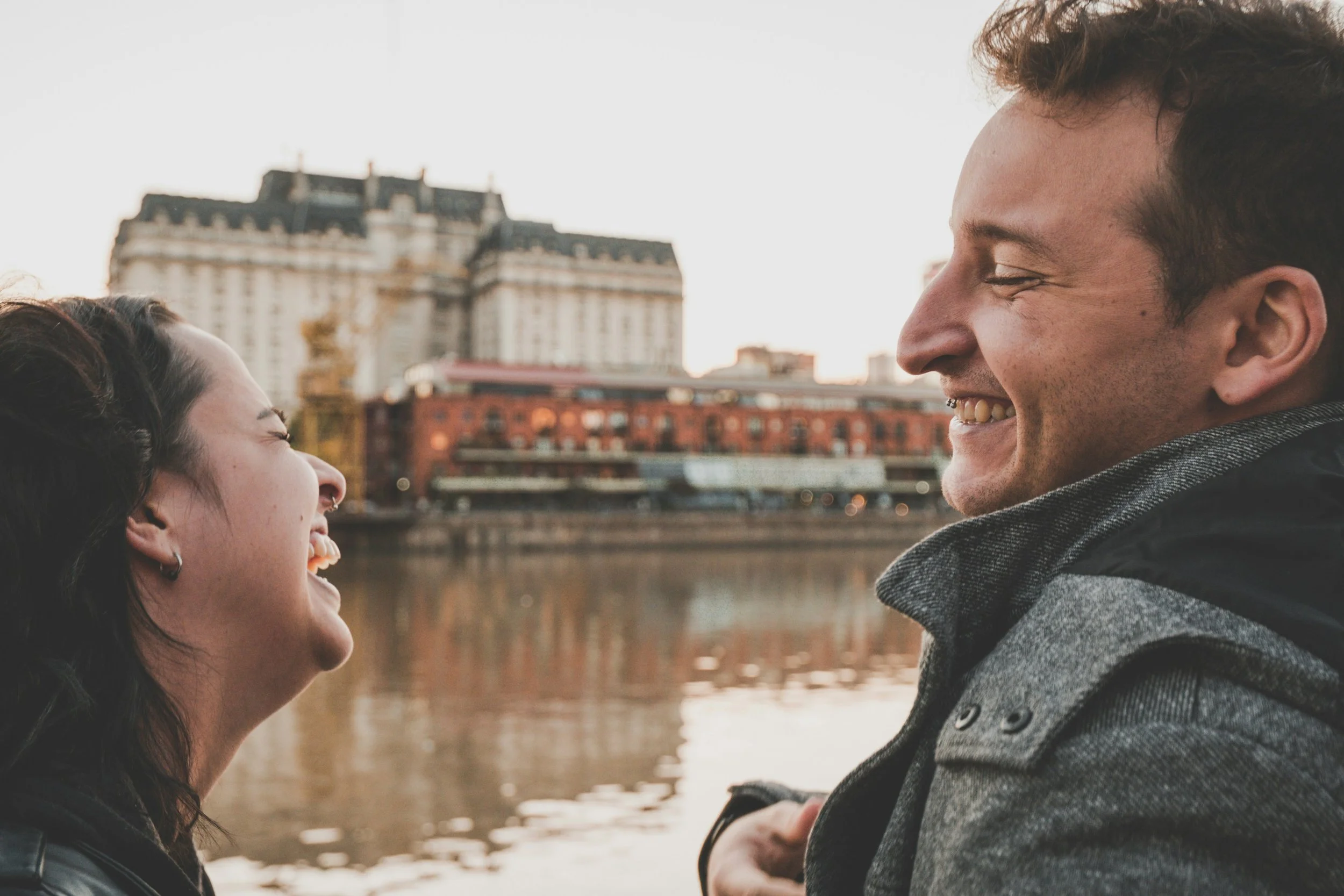 Couple laughing and talking genuinely, building emotional intimacy in relationship