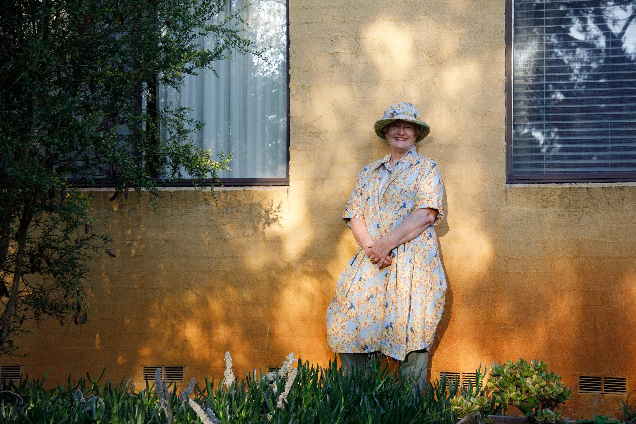 Environmental portrait of a woman standing outdoors in soft evening light during a relaxed creative portrait session. Mornington Peninsula
