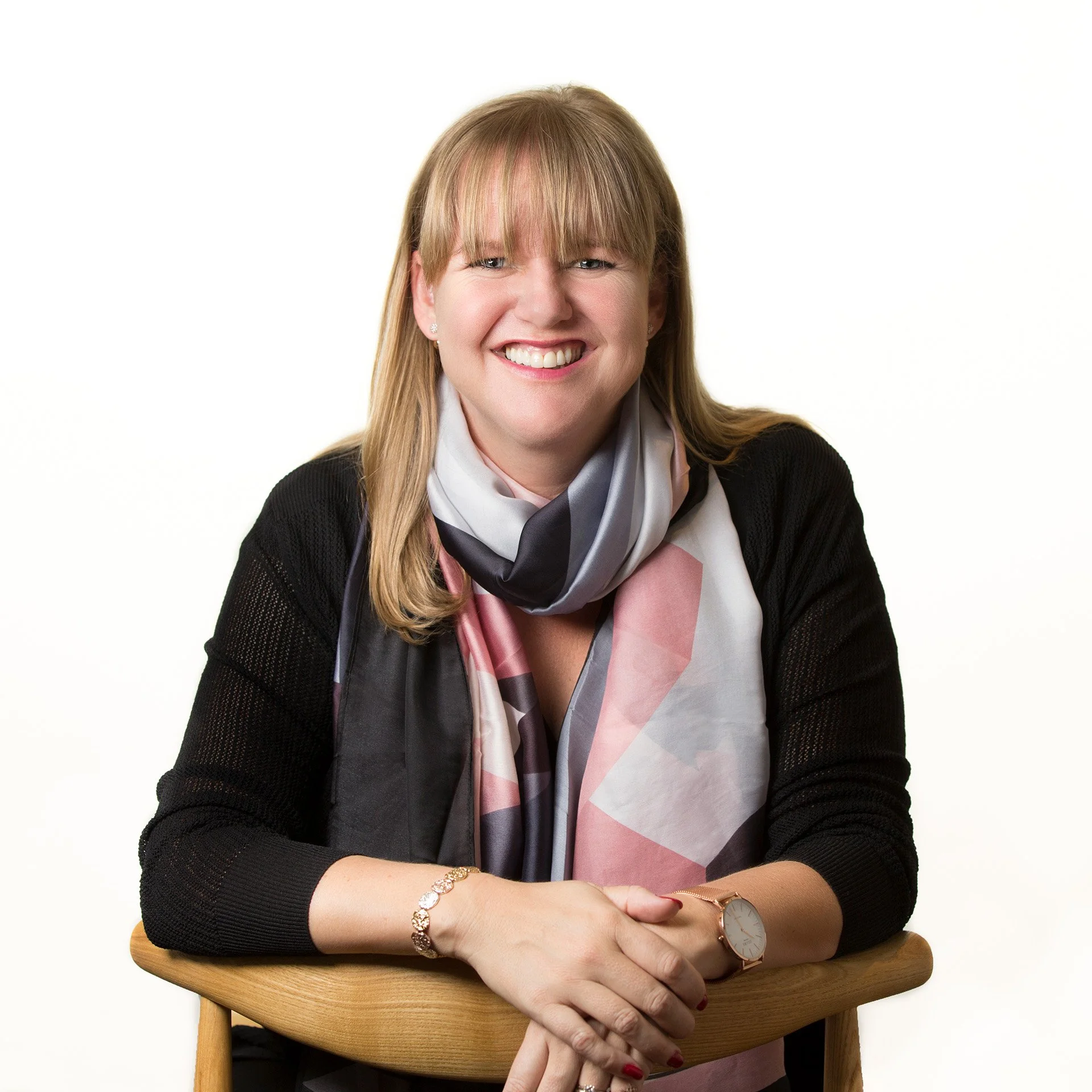 Polished corporate headshot of a woman with a white background by Natalie Finney Photography