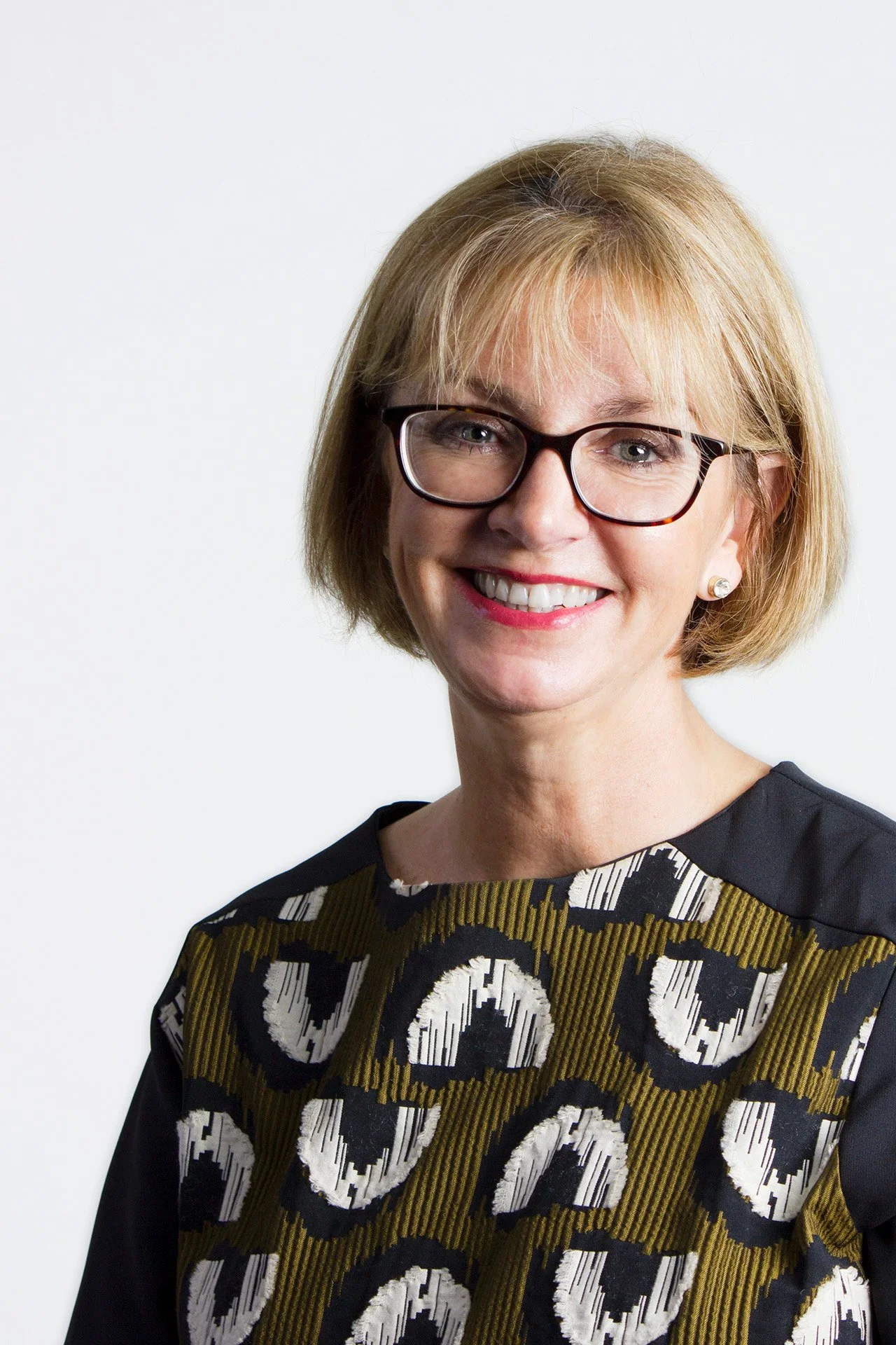 Polished corporate headshot of a woman with a white background by Natalie Finney Photography
