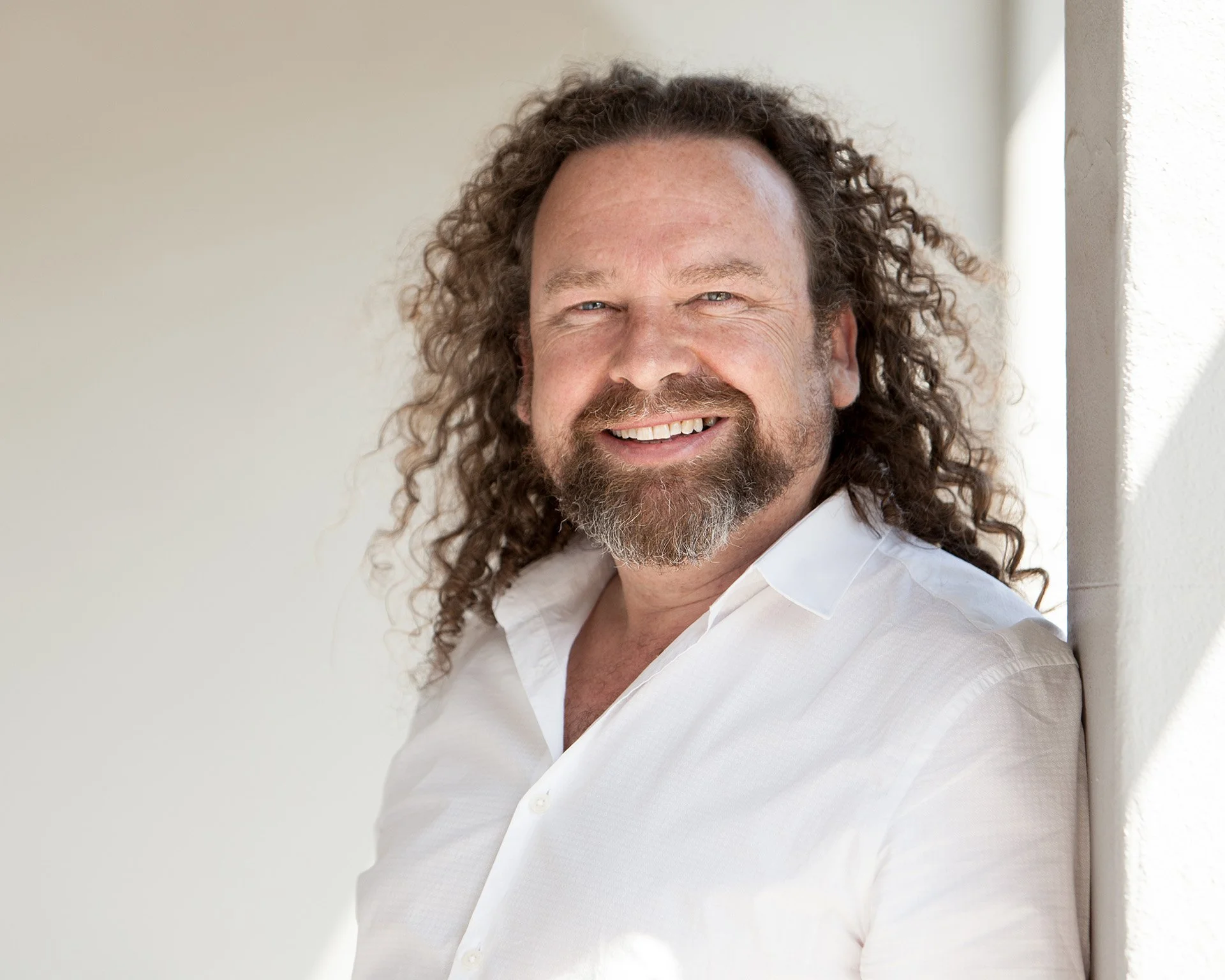 Relaxed natural light headshot of man outdoors by Natalie Finney Photography