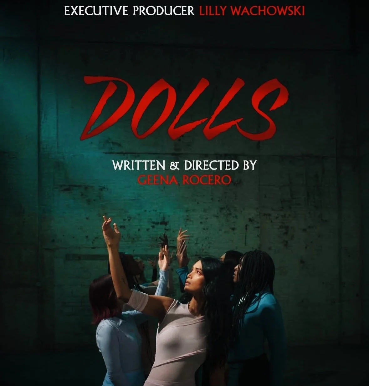 Title card for the play "Dolls," written and directed by Geena Rocero, with executive producer Lilly Wachowski. The background shows a group of diverse women raising their hands, standing against a dark textured wall.
