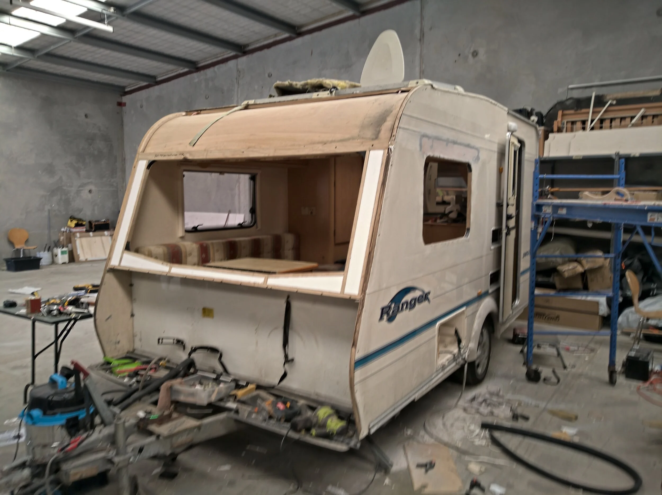 Front insulation refitted and repairs in progress on prior body modifications.