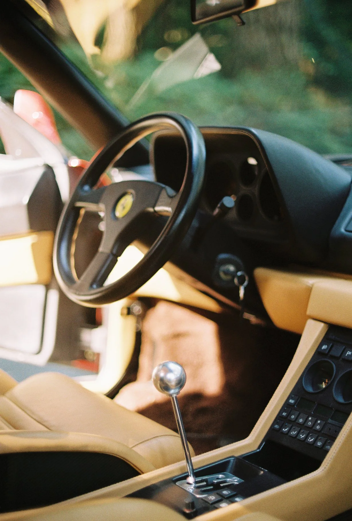 Ferrari 348 tan leather interior and gated manual shifter, photographed on Kodacolor 200 with a Nikomat.