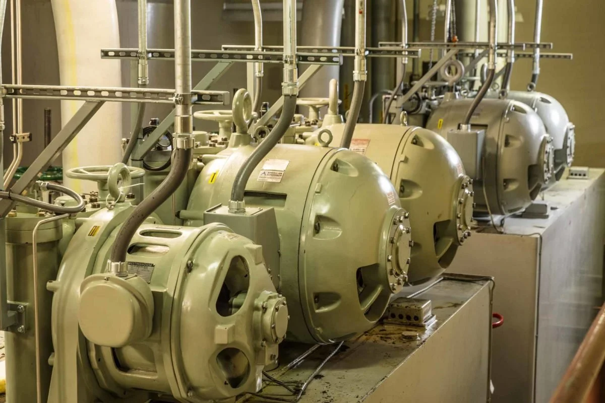 Commercial electrical installation showing metal conduits providing power connections to industrial motors and equipment.