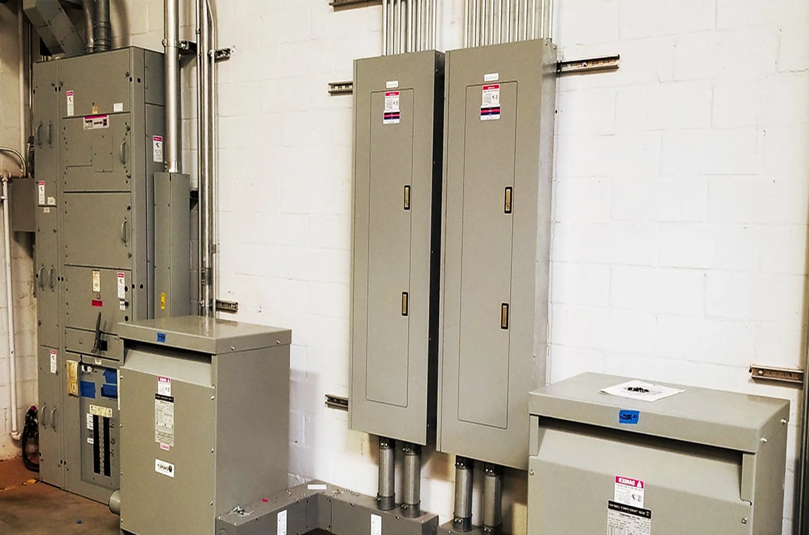 Newly installed commercial electrical panels and transformers after a recent upgrade