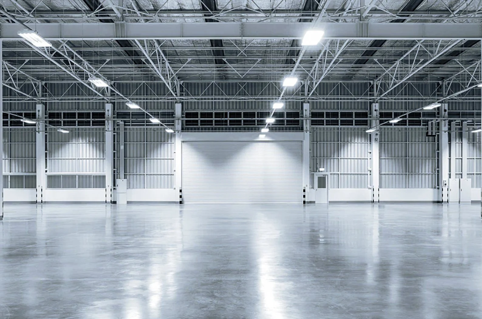 A brightly lit warehouse interior showcasing a recent retrofit with LED Linier high bay lights