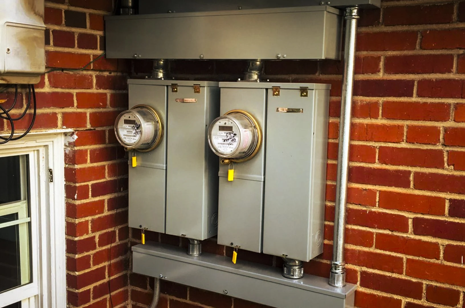 Two side-by-side 200 amp multimeter panel upgrades installed for a multi-unit dwelling.