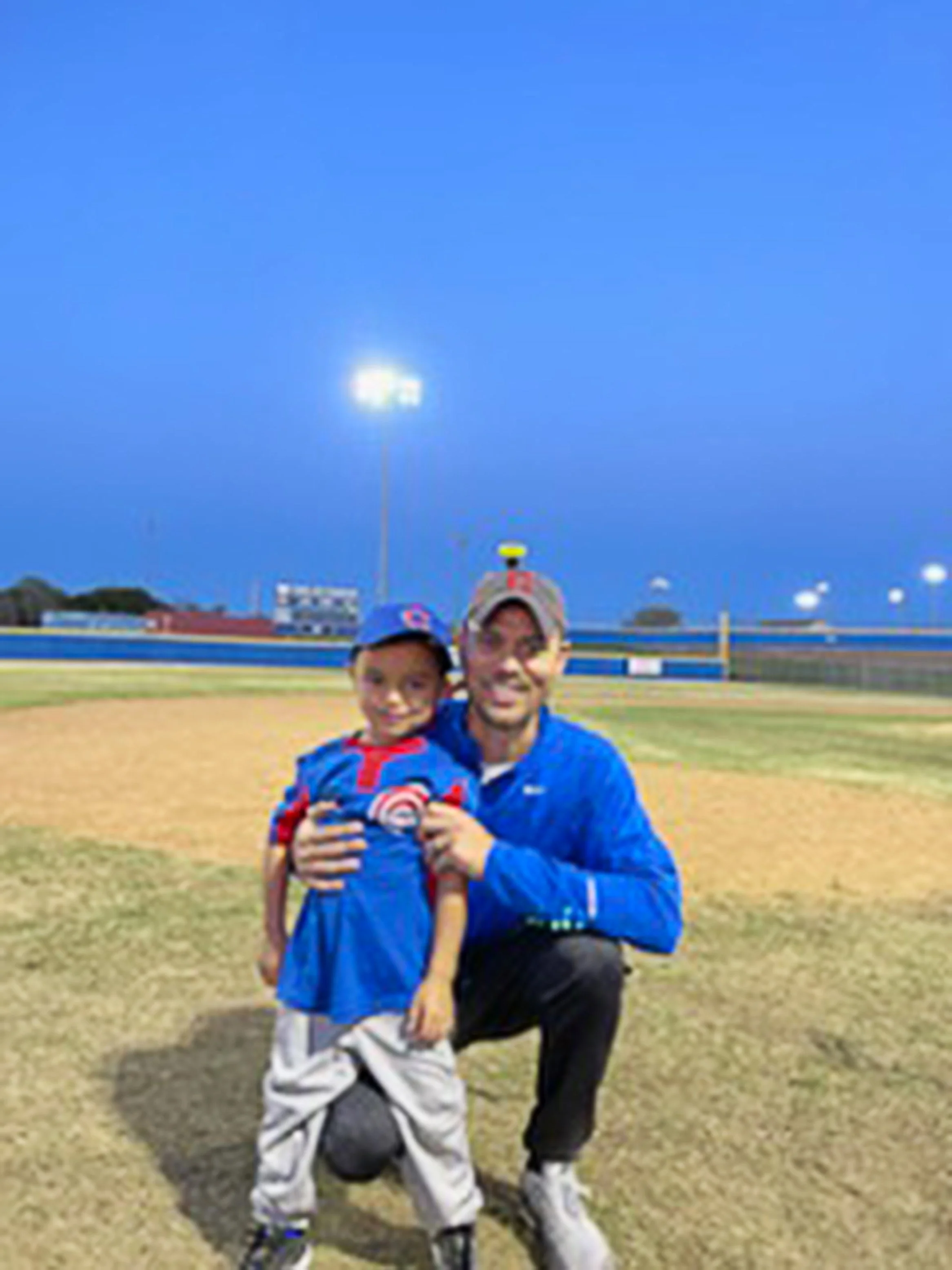 Matt and his son on a baseball field