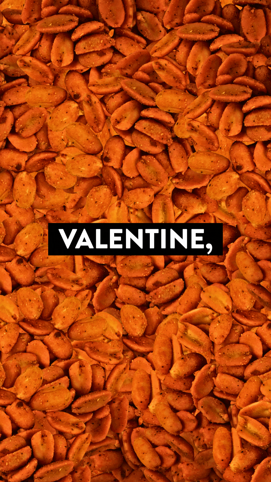 Decorated savory bread with cherry tomatoes, black olives, yellow peppers, and herbs on a beige plate.