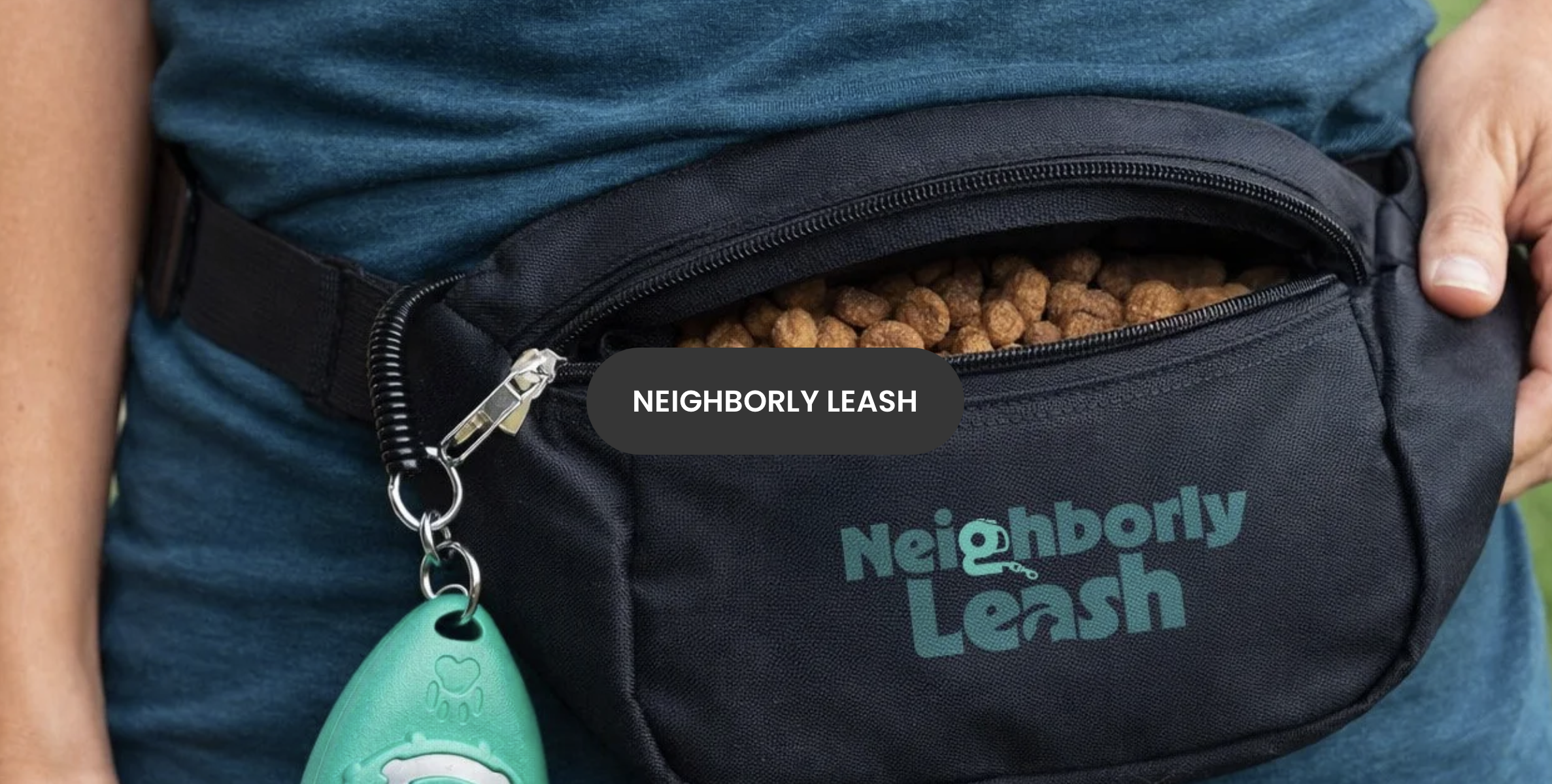 A person wearing a black waist pack with the label 'Neighborly Leash,' filled with dog kibble or treats, and a green dog leash attached.