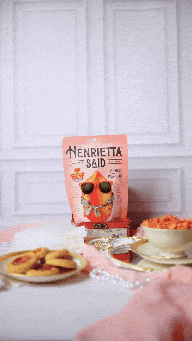 Gloved hand coming into frame and grabbing a peanut from a teacup