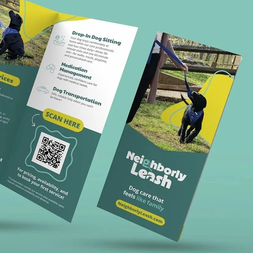 An artist using a drawing tablet at a desk, working on digital art on a computer screen displayed with a sun and a squiggly line.