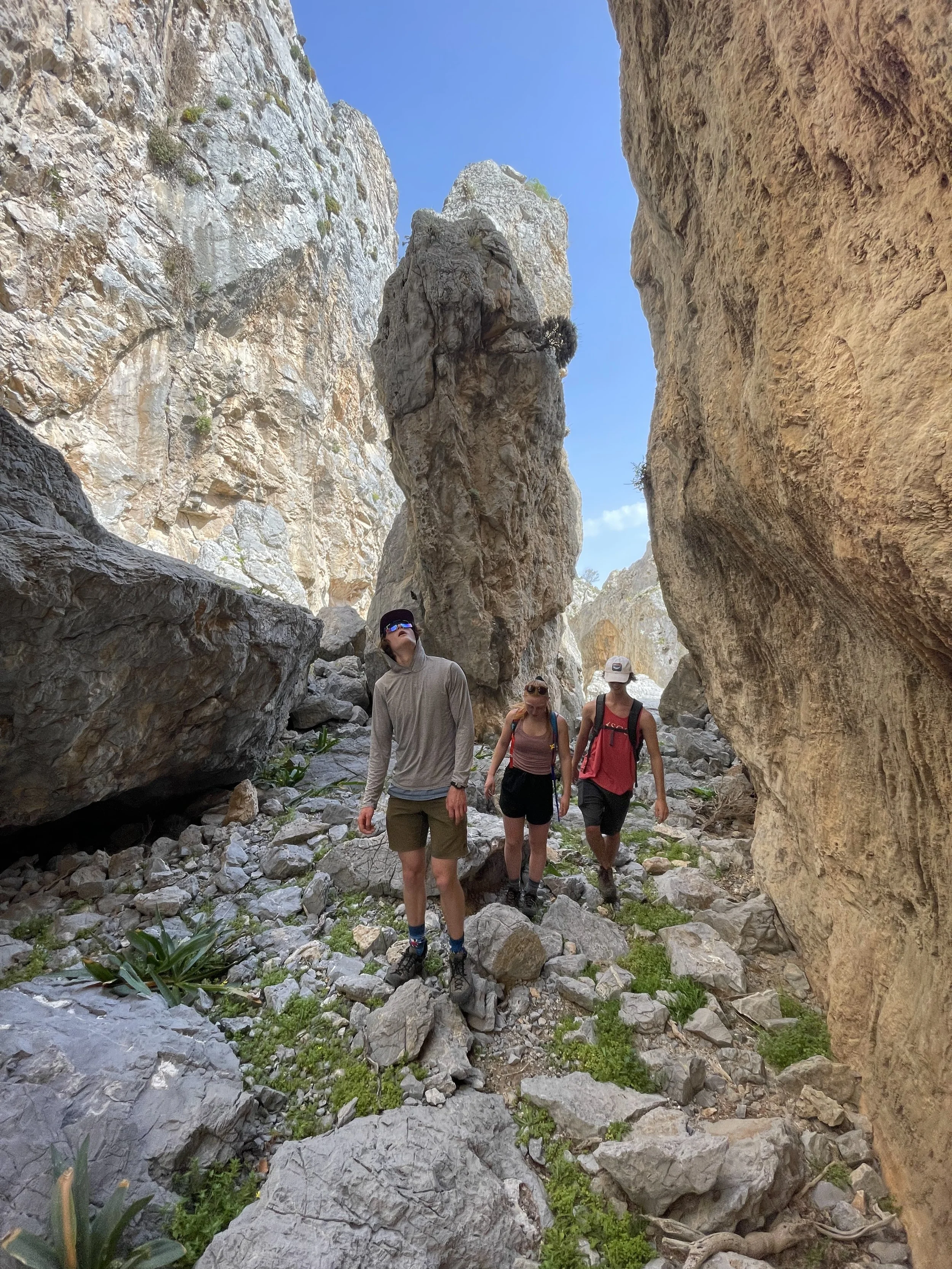 Students Tucker, Sylvie, and Alex walking through Princess Canyon on Telendos.