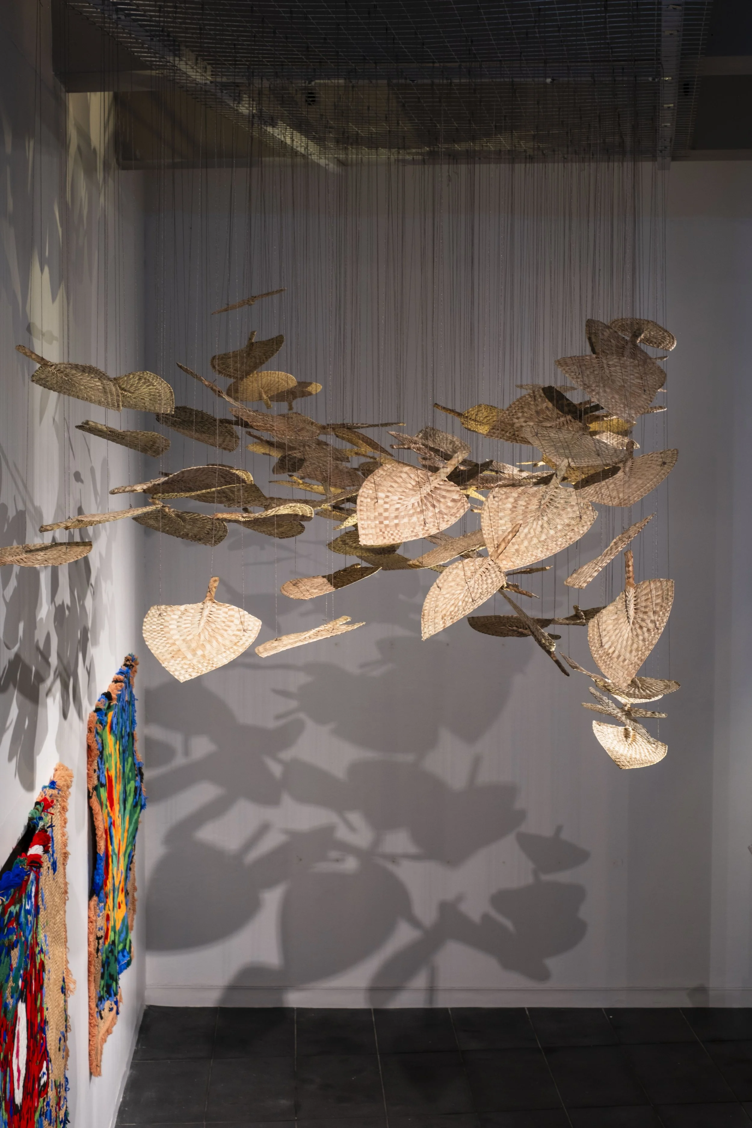  'Winds of Change' (2026) site-specific installation by Yuki Kihara. Ili supplied by The Sāmoa Victim Support Group (SVSG). Installation photo by Ted Whitaker. Courtesy of Te Pātaka Toi Adam Art Gallery, Aotearoa New Zealand. 