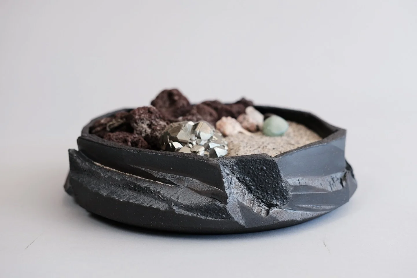 - custom bowl for N -
Requirements: medium sized bowl, looks like Iceland basalt columns, dark, moody, holds a &ldquo;rock terrarium&rdquo; to diffuse home sent like a modern pot-pourri. 
I used black clay and threw a short, thick and heavy bowl. Let