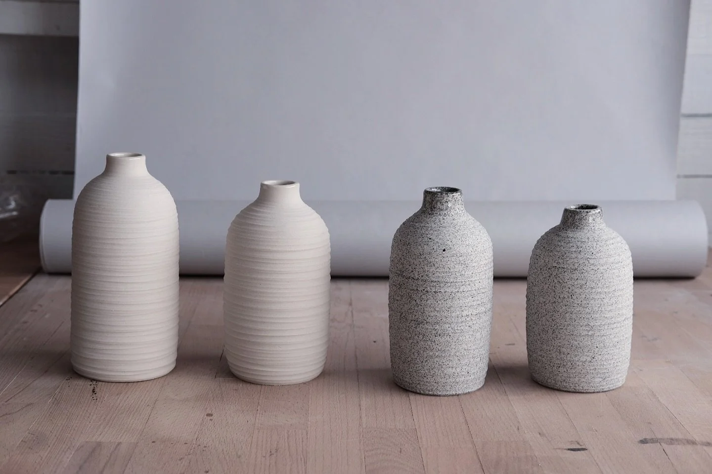 - oil oil -
New porcelain oil cruets just out of the kiln. 
The outside is left unglazed, I carved a &laquo;&nbsp;rope&nbsp;&raquo; texture to grab the light a create some visual interest on the surface only using the light and shadow. It adds grip a