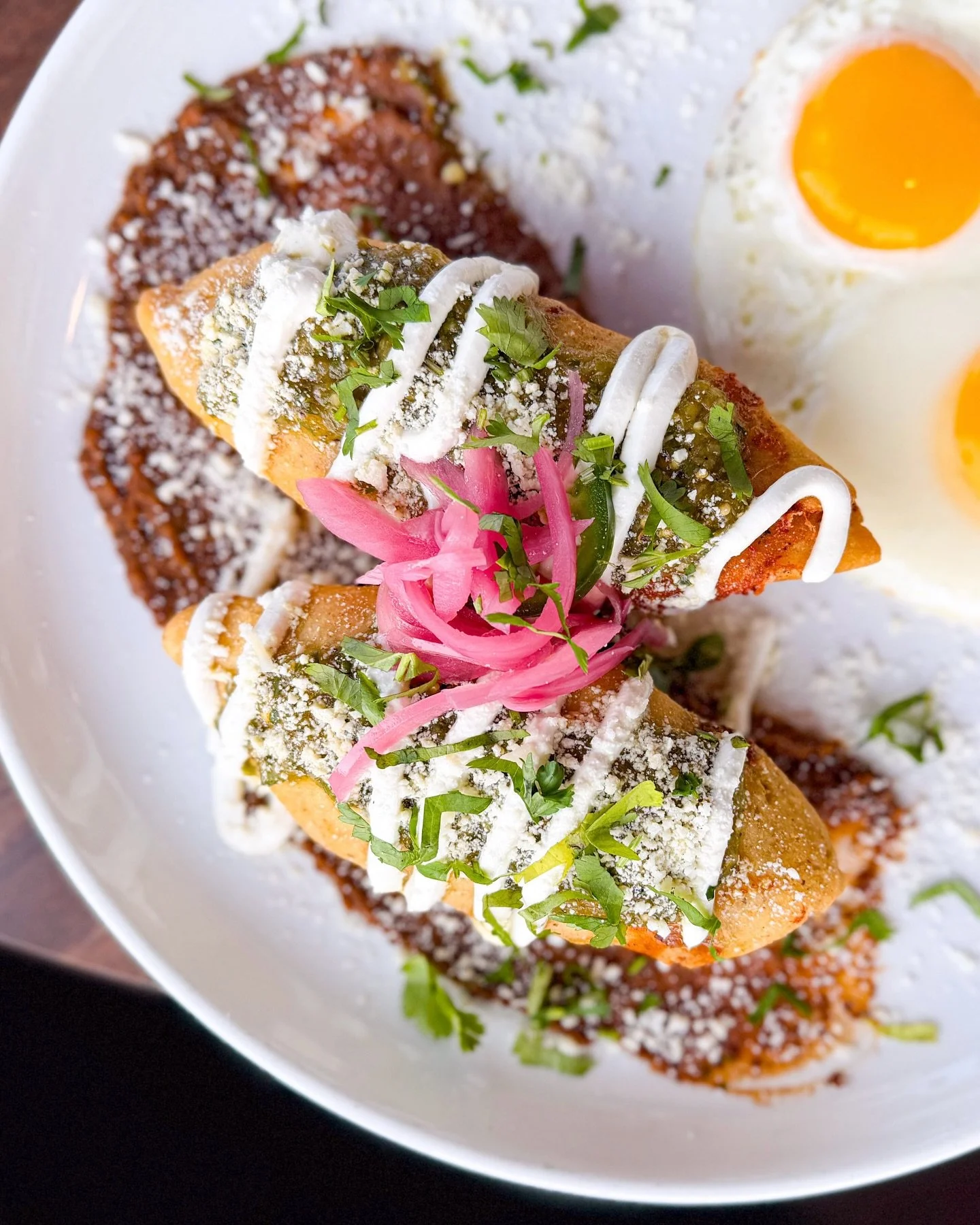 Two specials. Two locations. Two very good reasons to visit.

Breakfast Molotes (Shops of Legacy only)
Achiote-braised pork and Oaxaca cheese wrapped in masa, flash-fried until golden. Finished with refried black beans, crema, salsa verde, cotija, pi