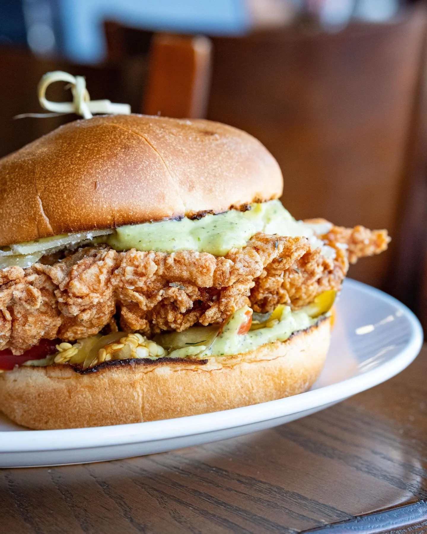 Our Avocado Caesar Fried Chicken Sandwich returns as a special starting today! 🥑 

Crispy fried chicken breast layered with creamy avocado Caesar sauce, shaved parmesan, pickled sweet peppers, and served on a toasted brioche bun.

Come grab one whil