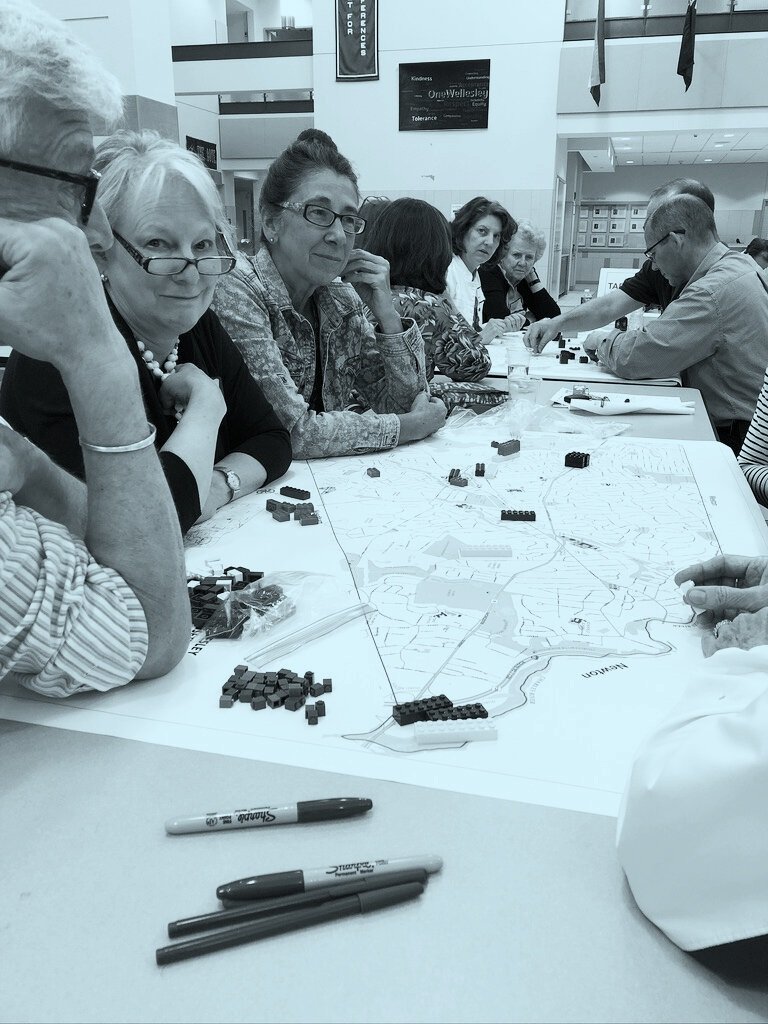 Group of Community Members sitting around map - JM Goldson (Copy)