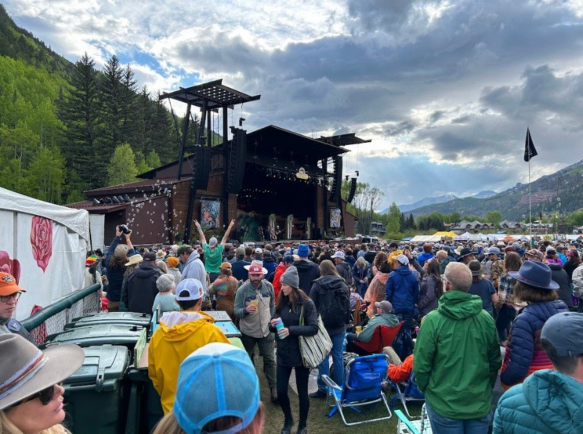 Crowd and performers at the Telluride Bluegrass Festival in the San Juan Mountains of Colorado
