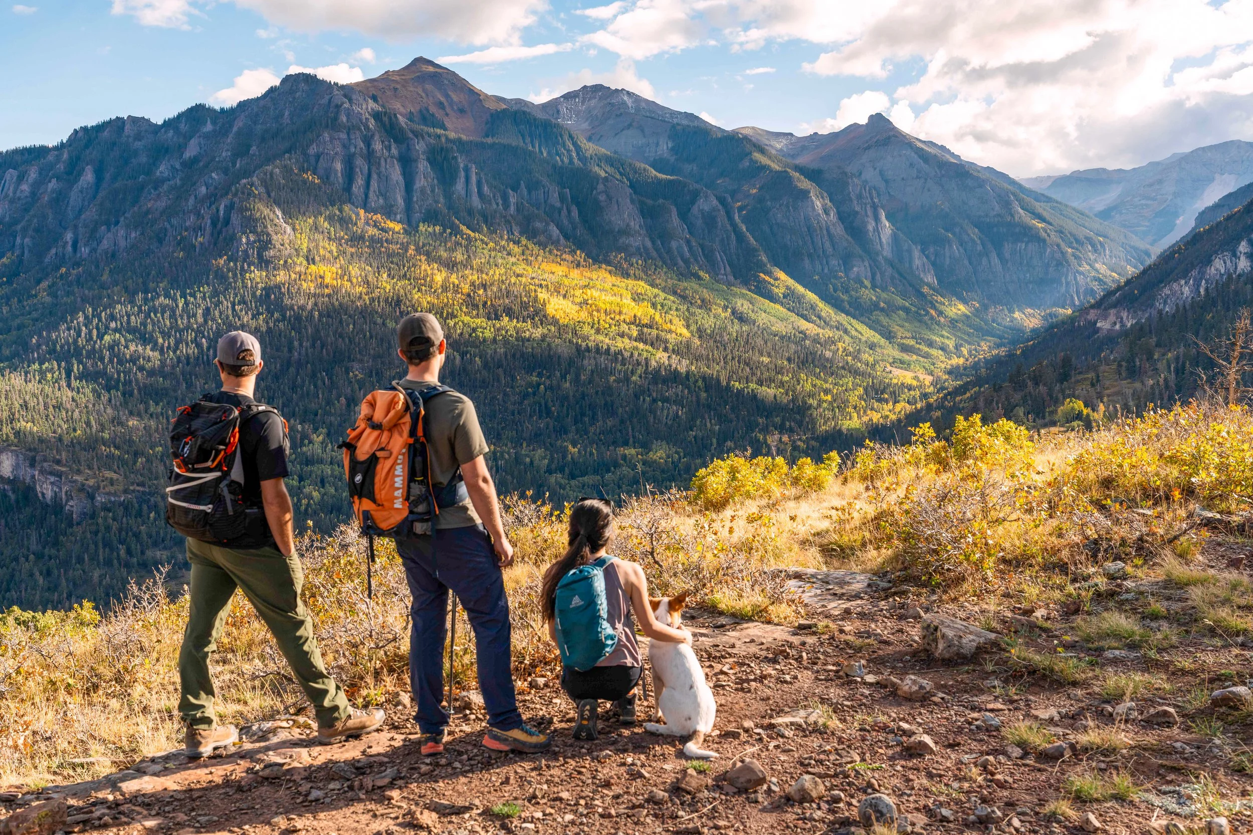 Three hikers on trail looking at mountains in Ouray