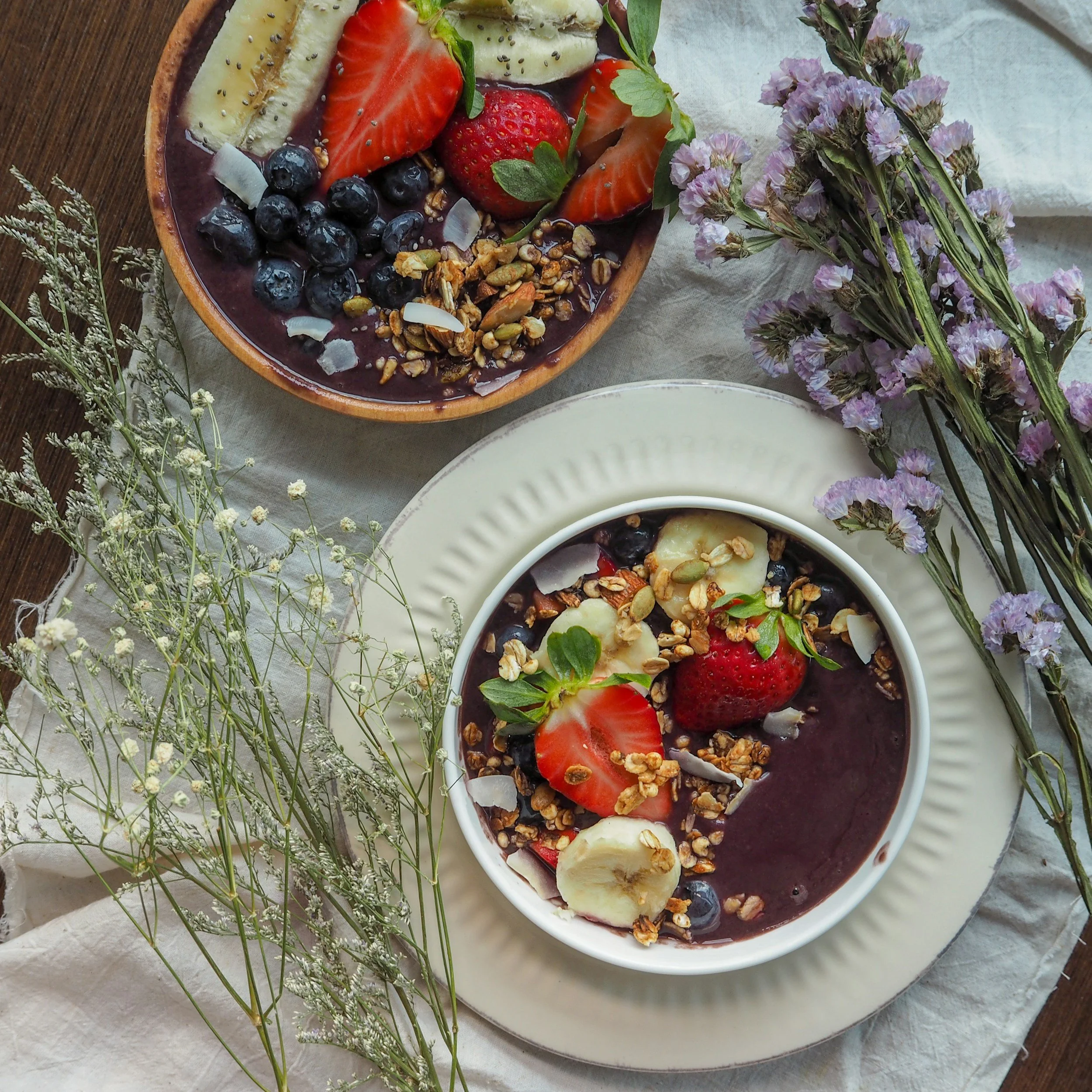 Acai Bowl decorated with fruits, granola and flowers