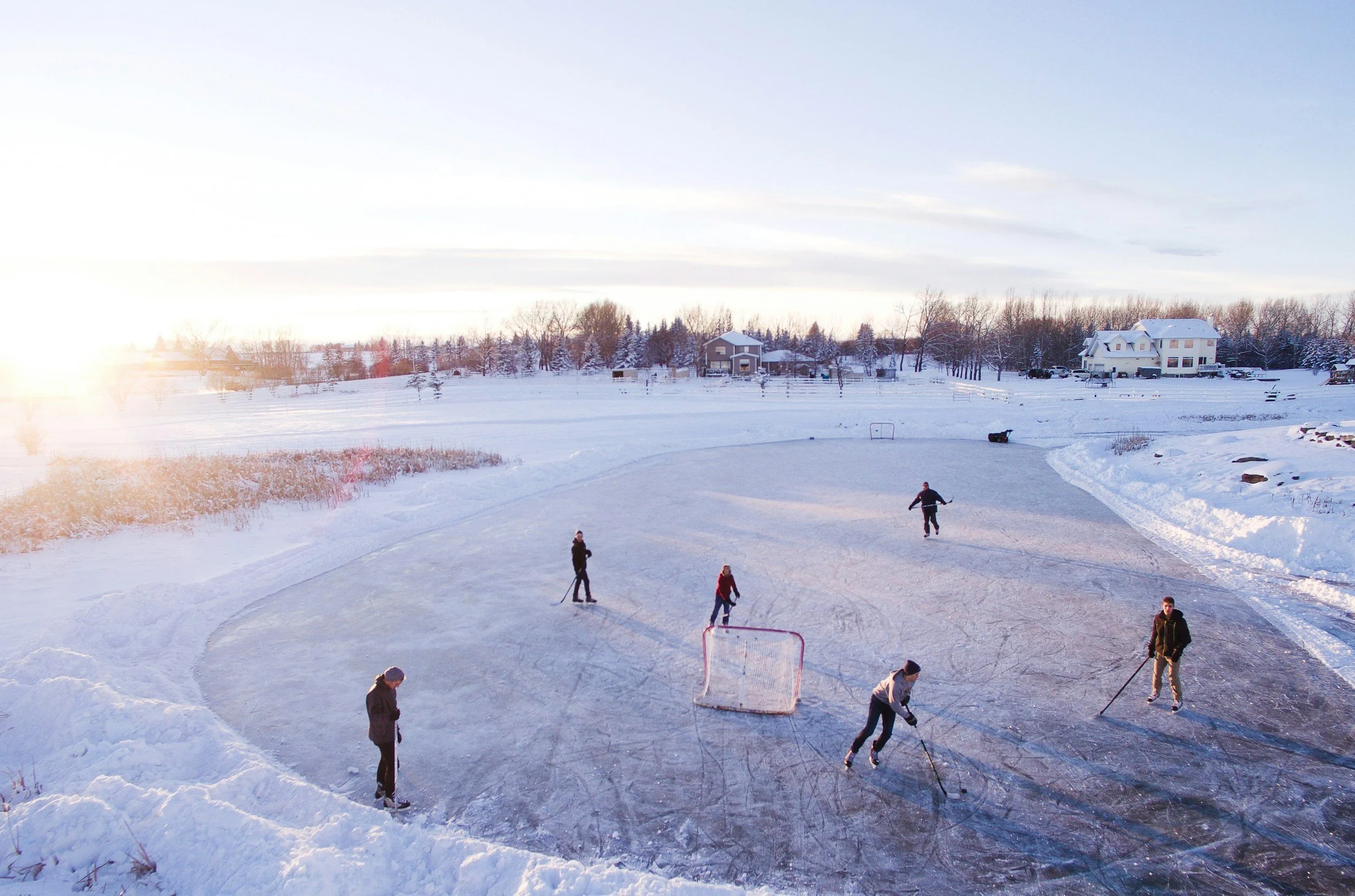 aeria view of friends playing hockey on ice.