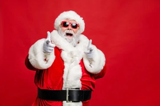 Santa wearing sunglasses pointing
