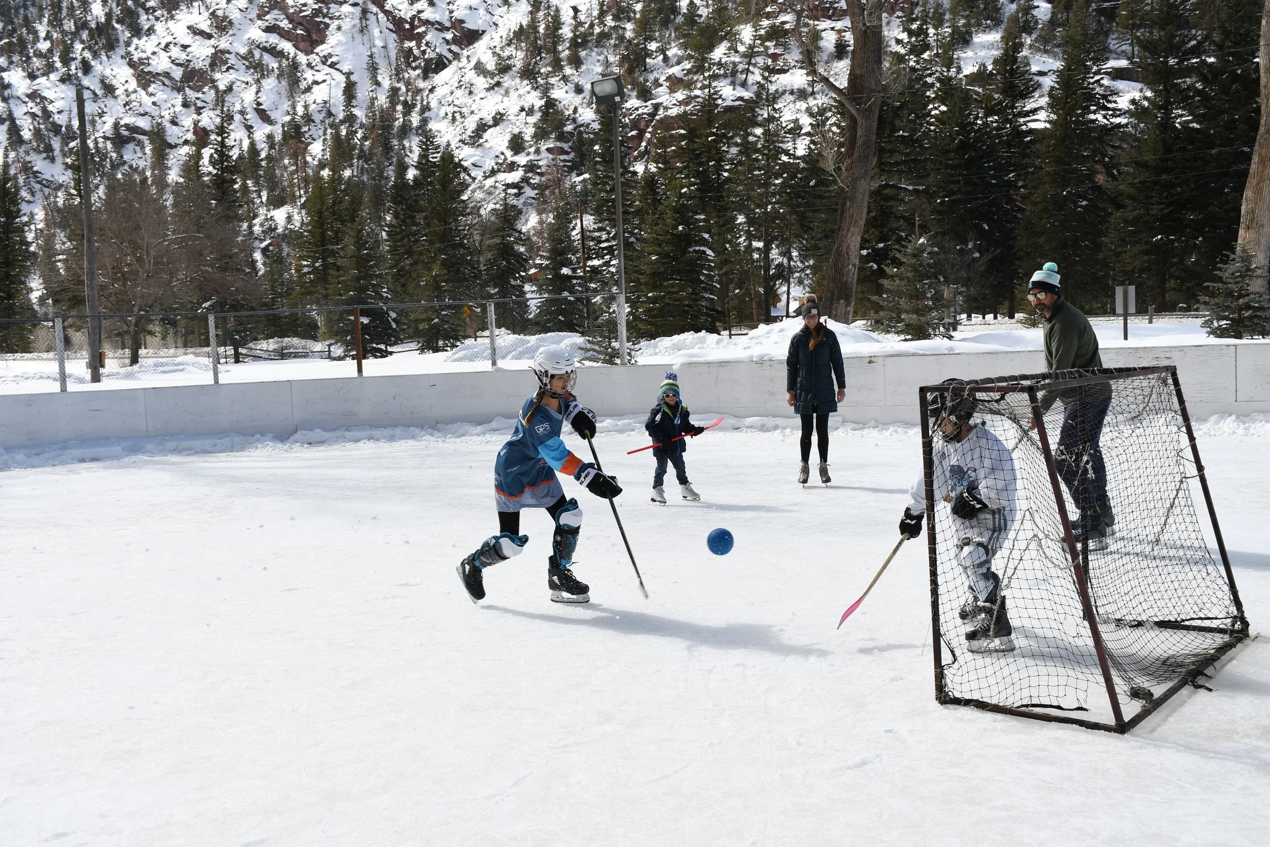 Ice rink in Ouray where people are playing hockey