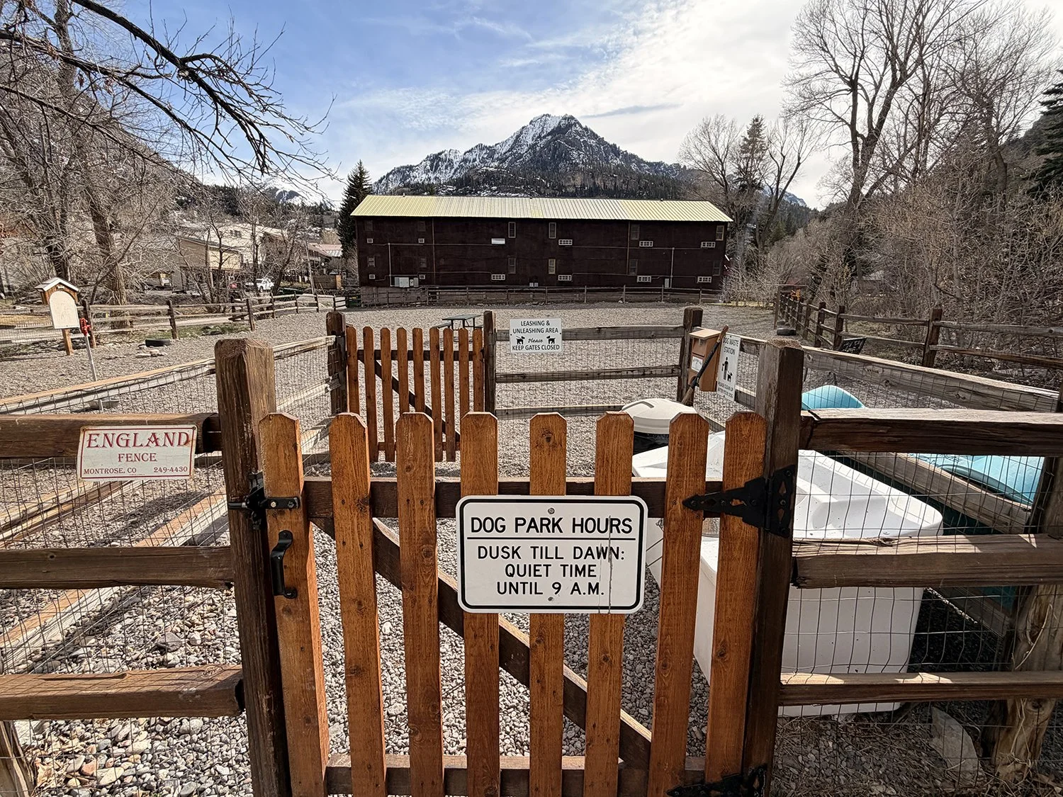A gate and a building with a mountain in the background.