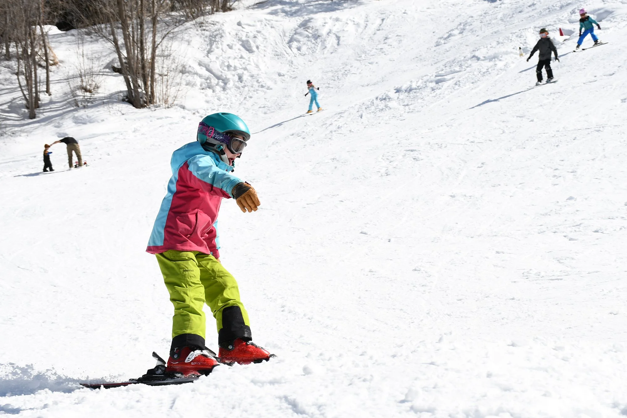 Six people ski on snow