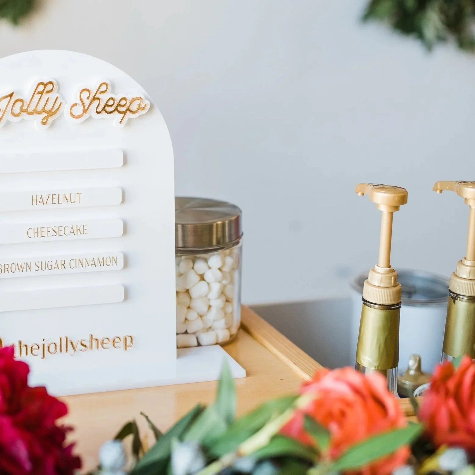 A close up of The Jolly Sheep's hot chocolate bar with mini marshmallows and syrup pumps visible