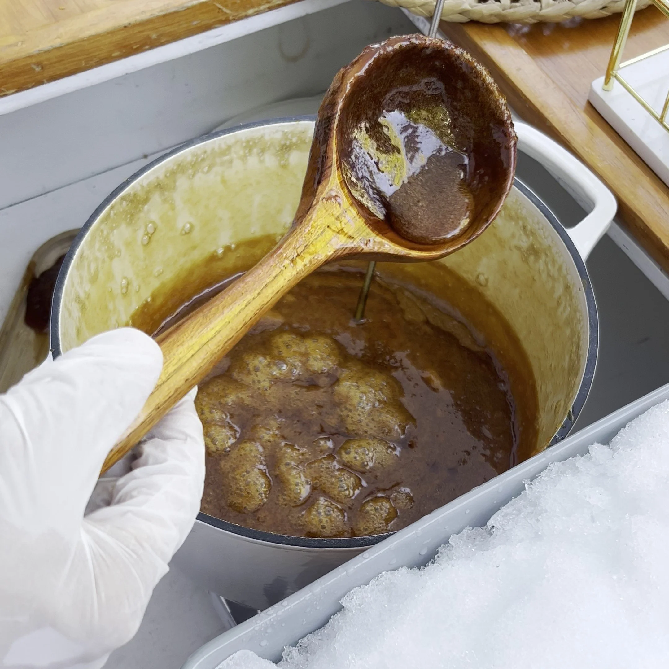 Melted maple syrup in a pot and large spoon