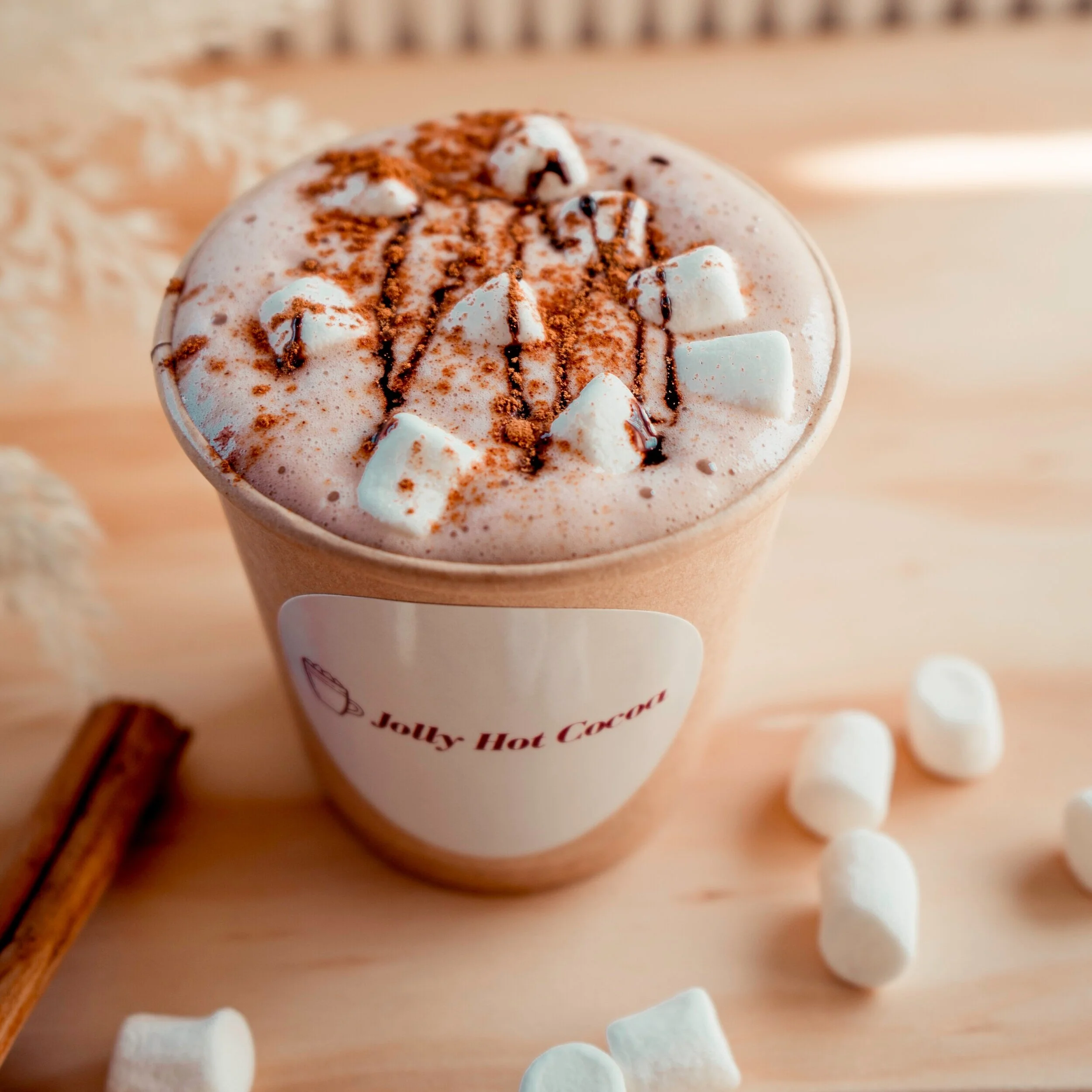 A close up of The Jolly Sheep hot cocoa cup with custom label