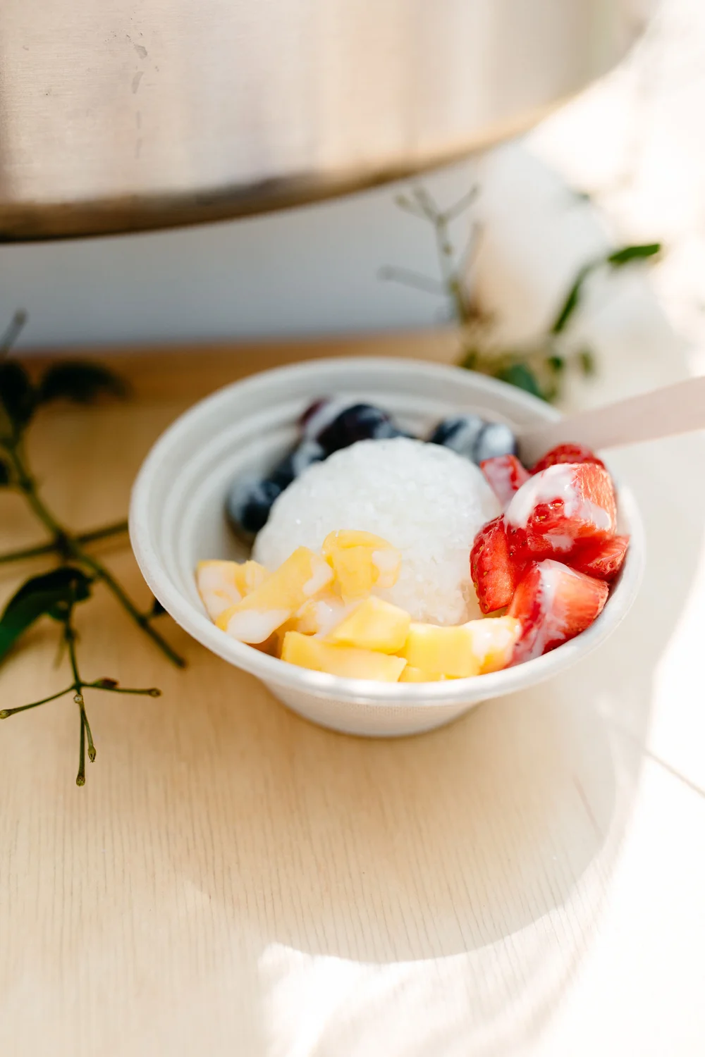 A bowl of The Jolly Sheep's signature shaved ice with sweet condensed milk and fresh fruit topping.