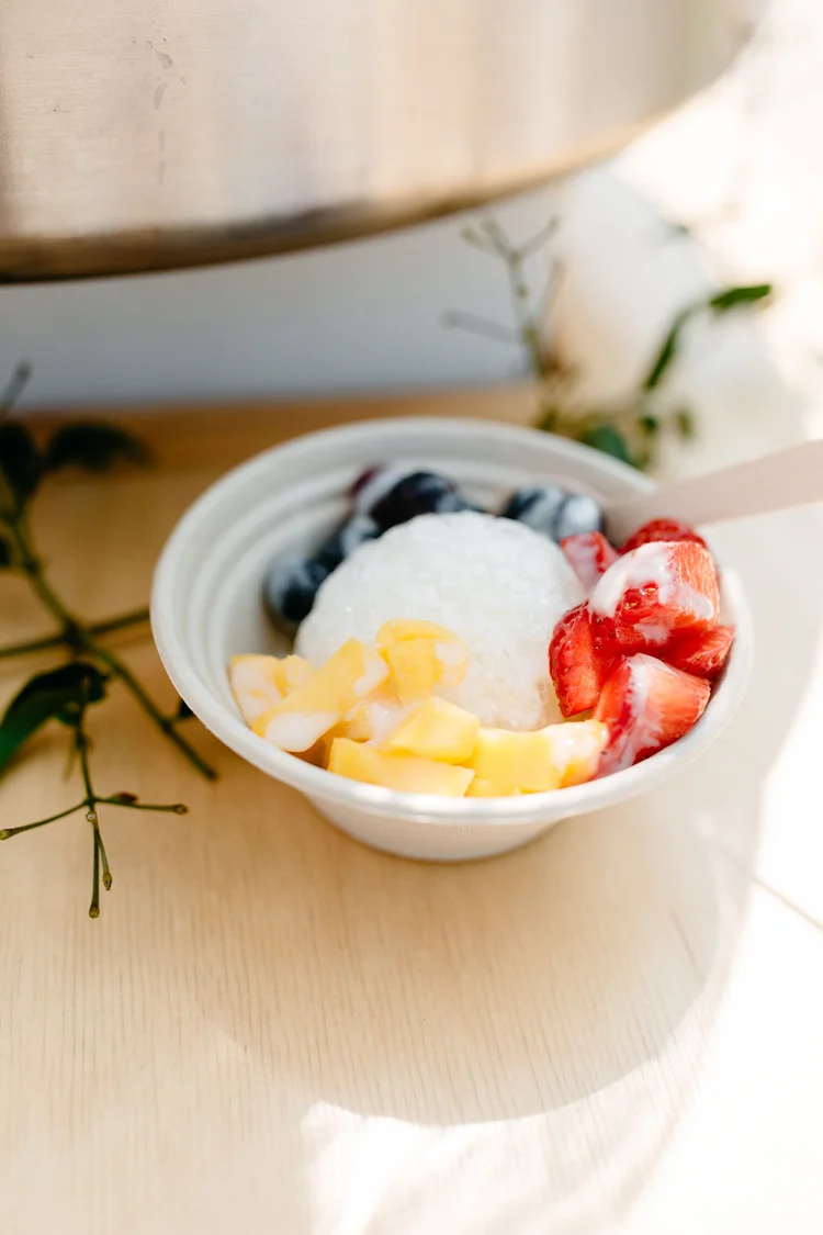 A bowl of The Jolly Sheep's signature shaved ice with sweet condensed milk and fresh fruit topping.