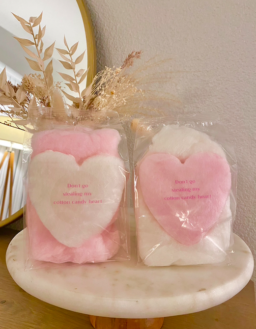 custom label heart shaped cotton candy favors in pink and white on a styled backdrop