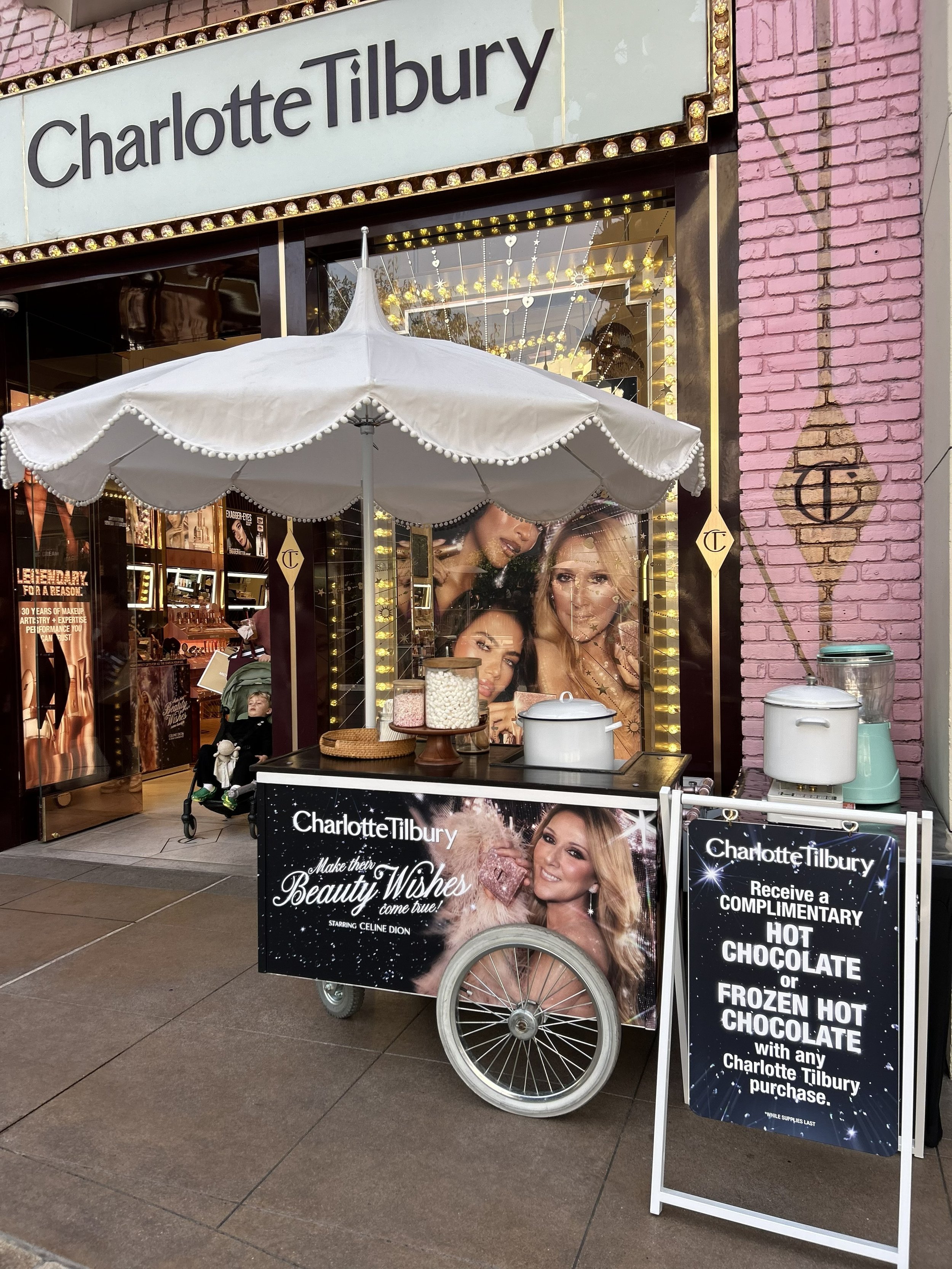 A snapshot of The Jolly Sheep hot chocolate cart in front of a Charlotte Tilbury store for a holiday activation
