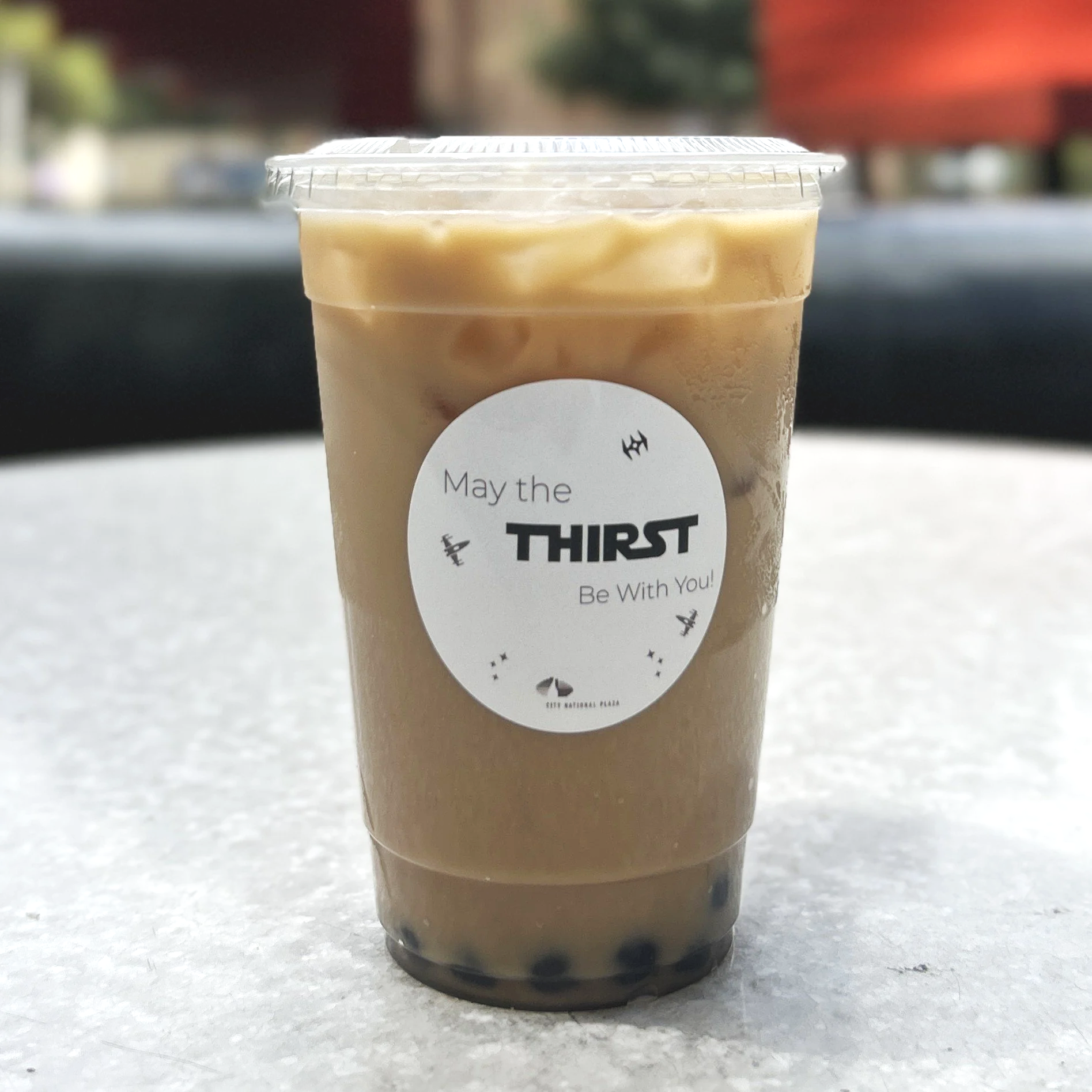 A close up of a boba cup with a custom label for The Jolly Sheep catering