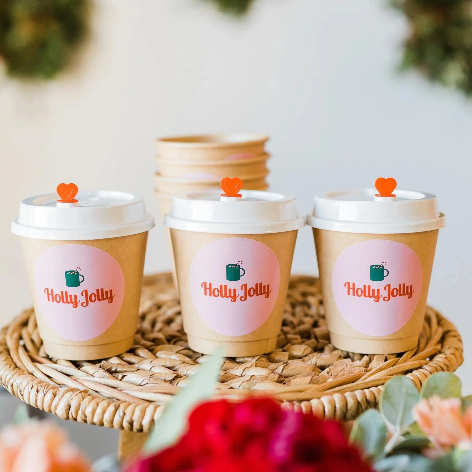 A close up of hot chocolate cups with lids and full color custom labels on a tray from The Jolly Sheep