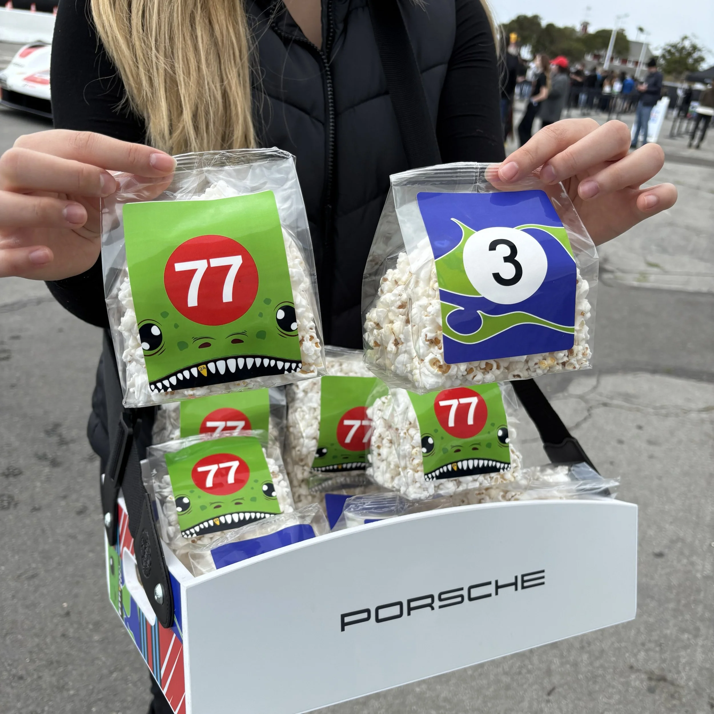 custom branded popcorn bags for a porsche event with car designs on the labels