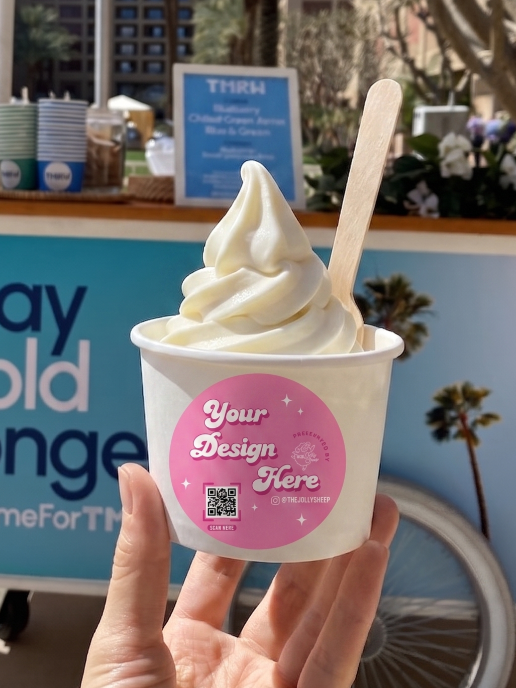 A cup of soft serve ice cream with a custom designed label