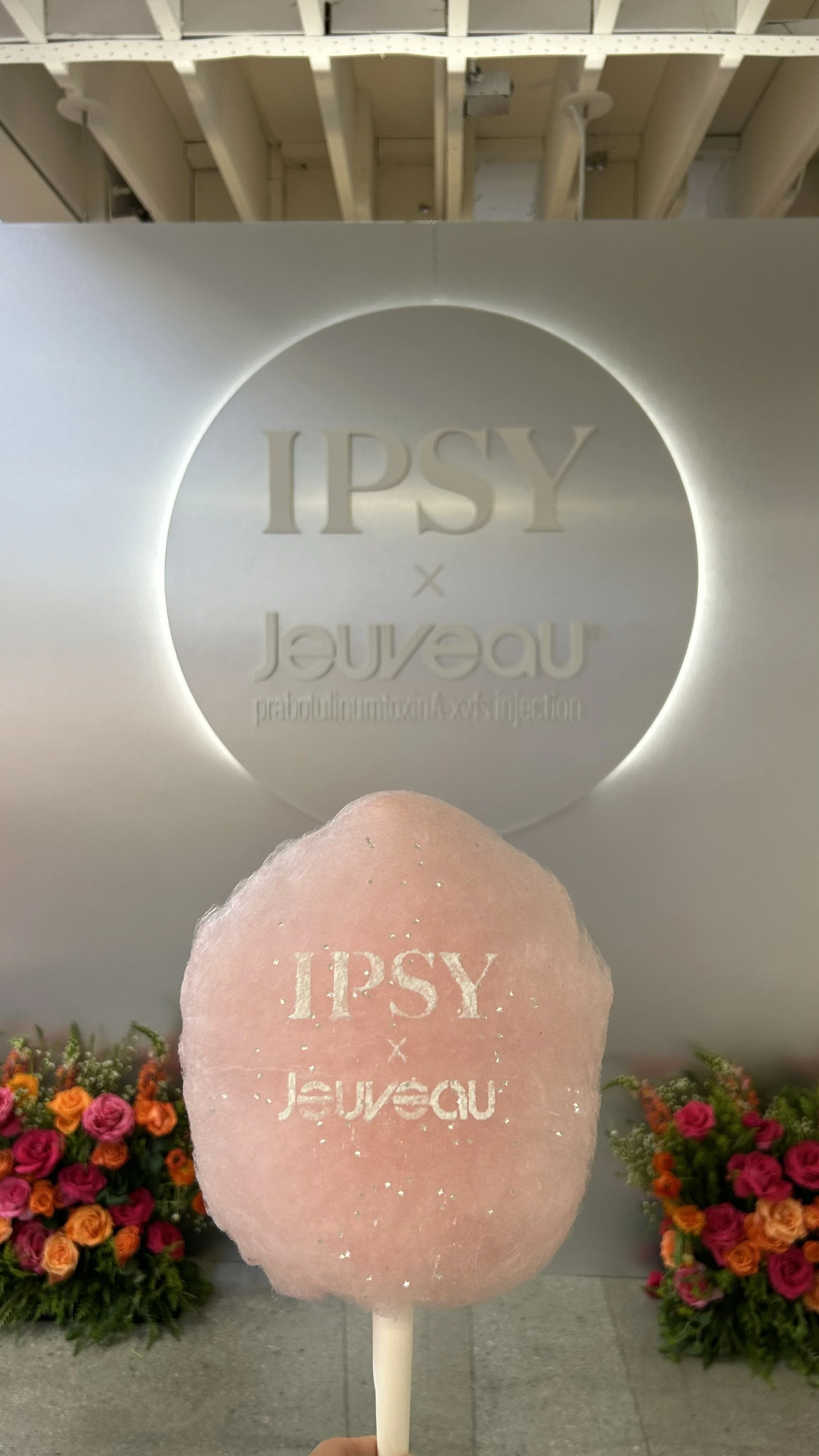 a close up of a cotton candy with an edible logo imprinted on the surface