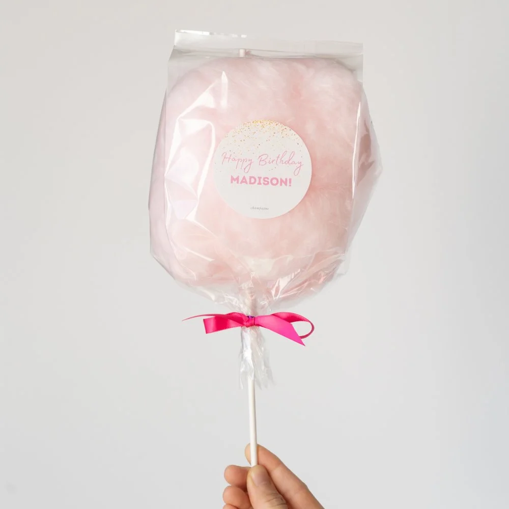 cotton candy on a stick with a happy birthday madison custom label