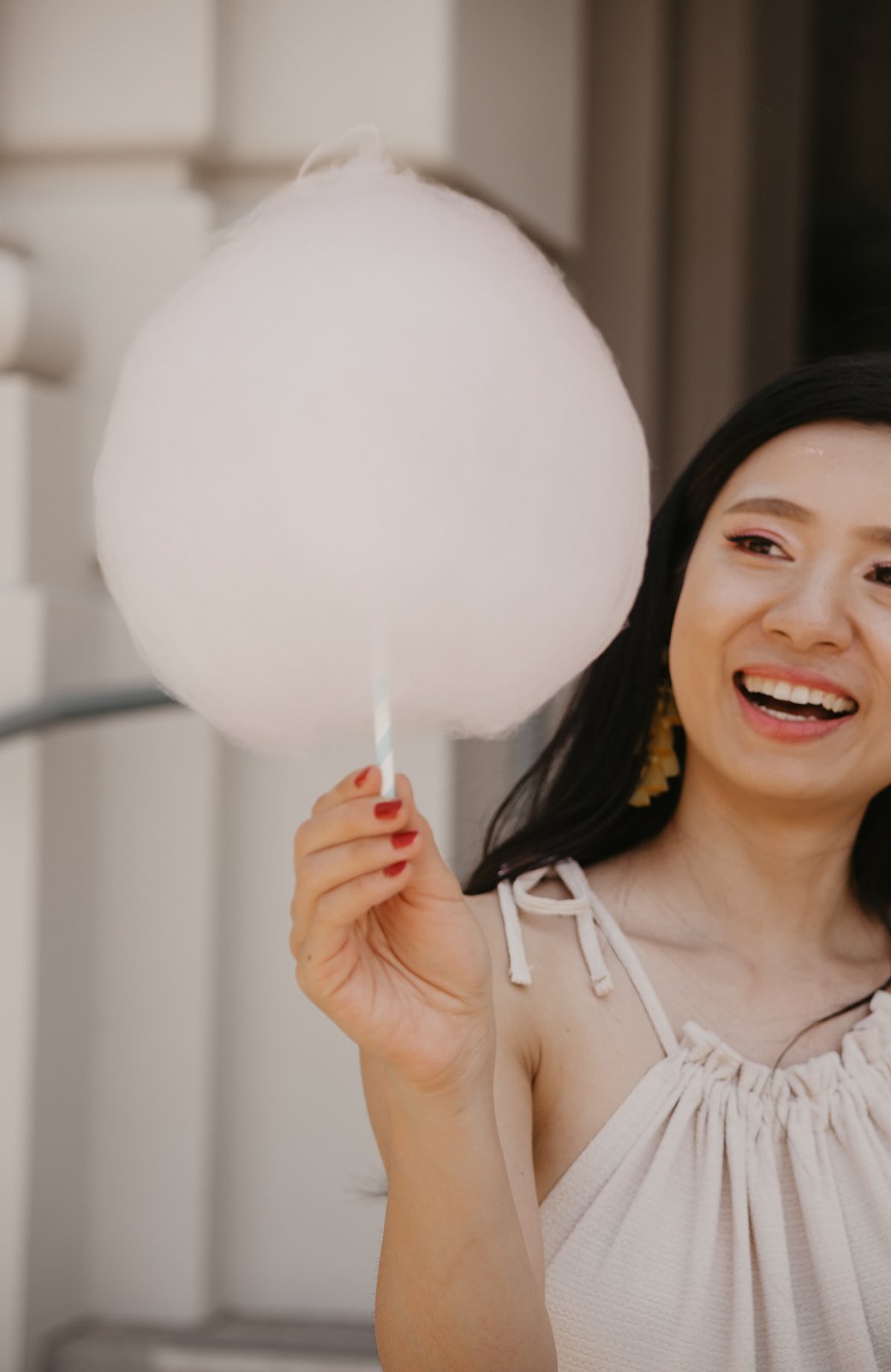 Girl holding up a cotton candy like a light bulb aha happy moment