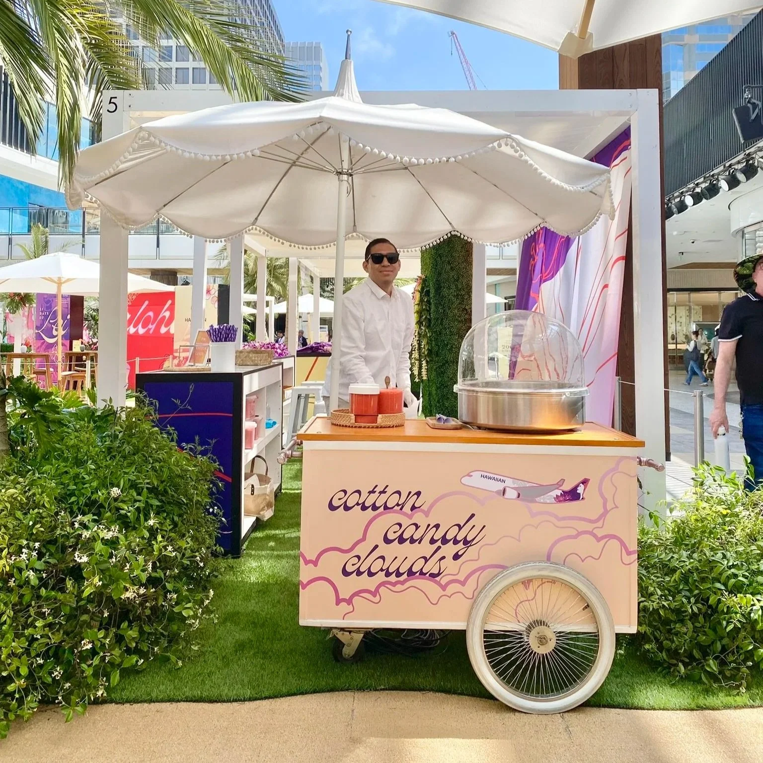 Live cotton candy cart catering at an outdoor brand activation event