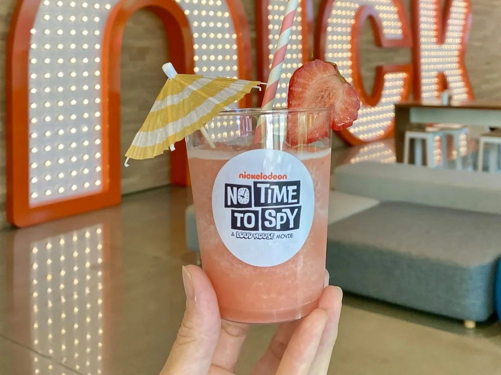 The Jolly Sheep strawberry slushy service showing a fresh slushy cup with umbrella and fresh-cut strawberry garnishes for a Nickelodeon employee party.