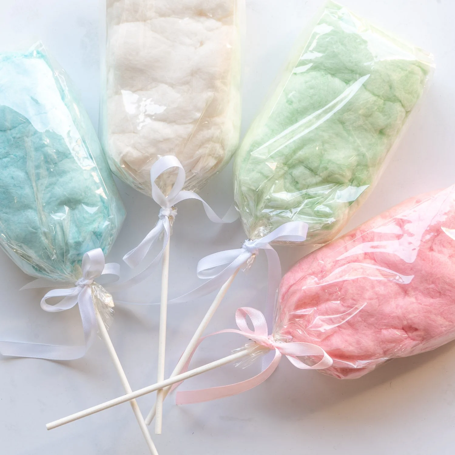 mini cotton candies on a stick in 4 different colors