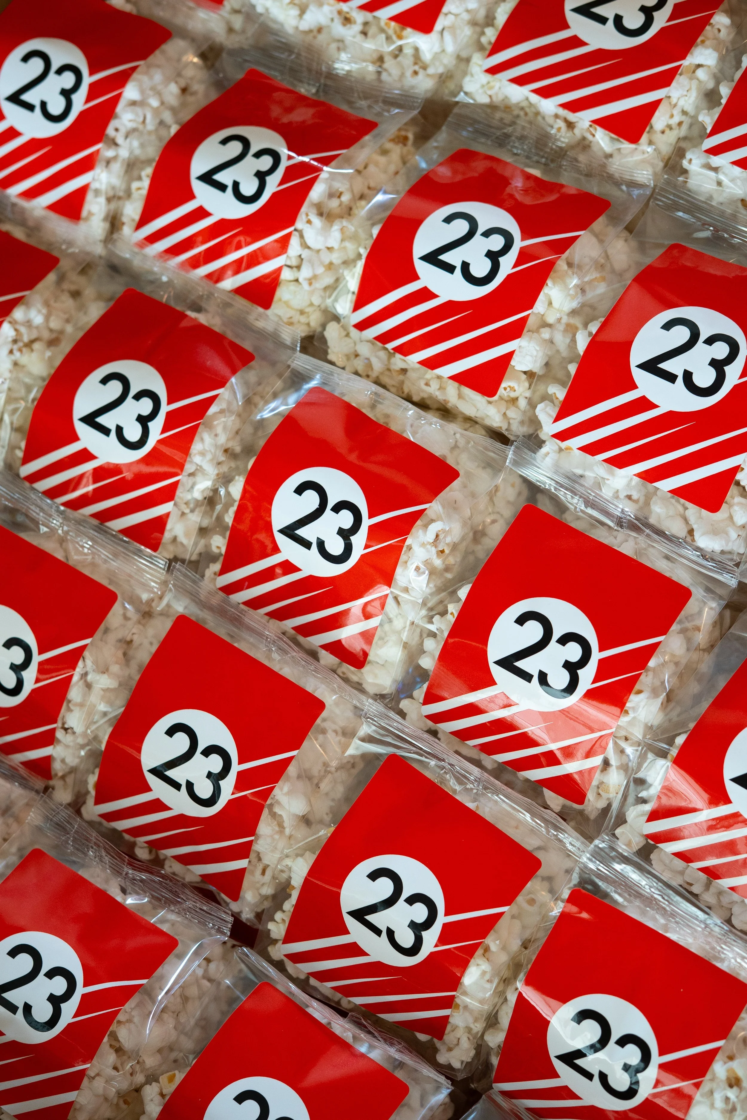 Porsche custom-printed popcorn bags matched to red race car liveries at Air|Water, Costa Mesa